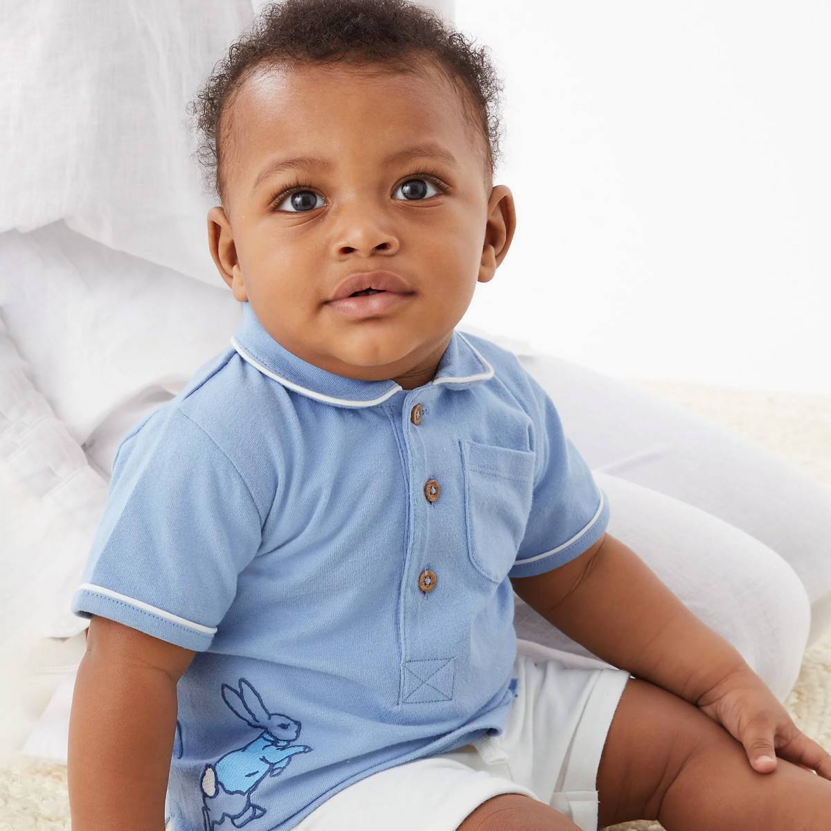 Baby wearing Peter Rabbit polo shirt. Shop for baby boys